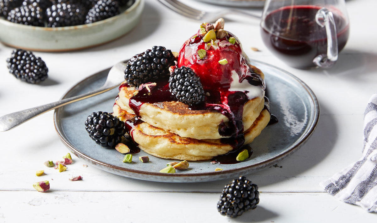 Fluffy pancakes with blackberry sauce